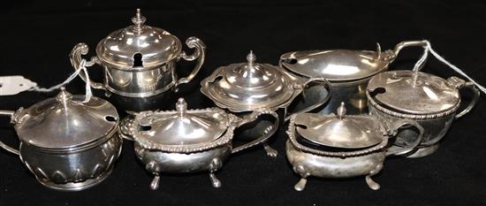 Seven silver mustards, various (one lacking blue glass liner)
